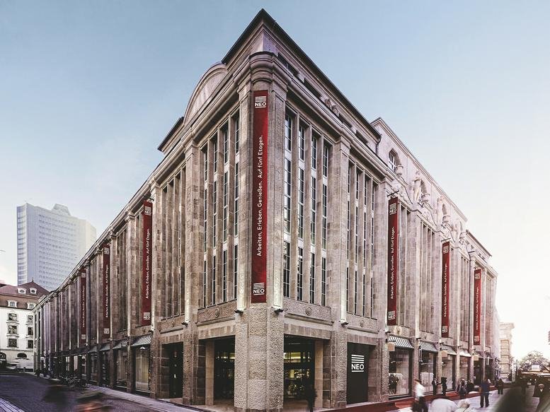 Exterior view of the historic stone-facade building at 35, Petersstraße, Leipzig with tall arched windows.