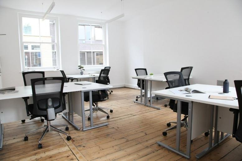 Spacious open-plan workspace at 38-39 St John's Lane featuring wooden floors and natural light.