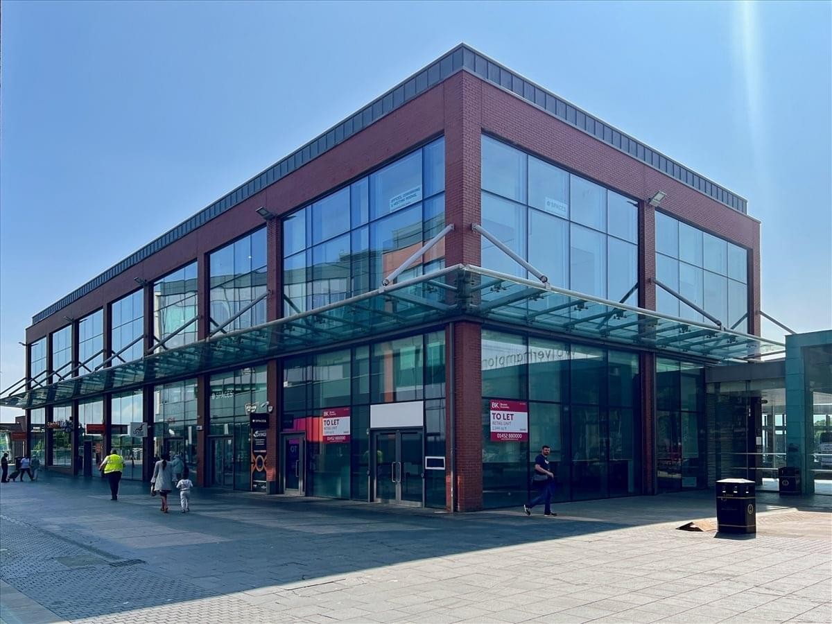 Exterior view of the modern glass-fronted 4-5 Victoria Square building with red brick accents.