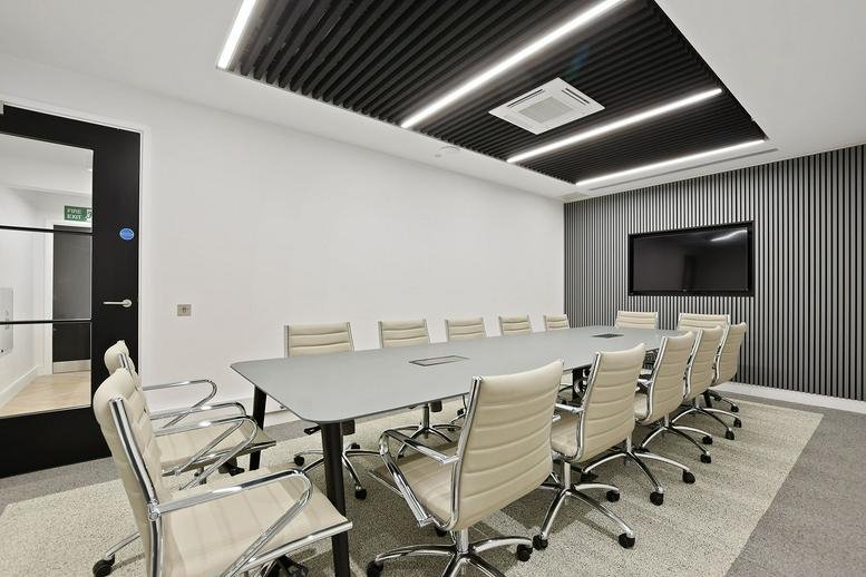 Spacious boardroom with a long grey table and modern slatted ceiling at 4 Breams Buildings.