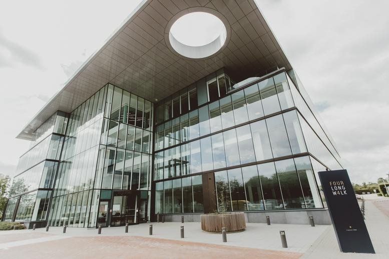 Exterior view of the glass-facade building at 4 Longwalk, Stockley Park.