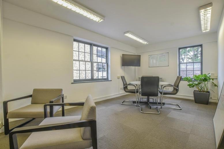 Meeting room at 4 Post Office Walk with a central table and natural light from large windows.