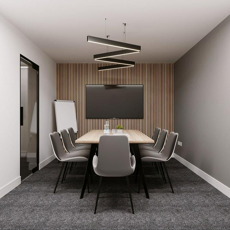 Professional meeting room at 40 Warton Terrace with a central wooden table and modern zig-zag lighting.