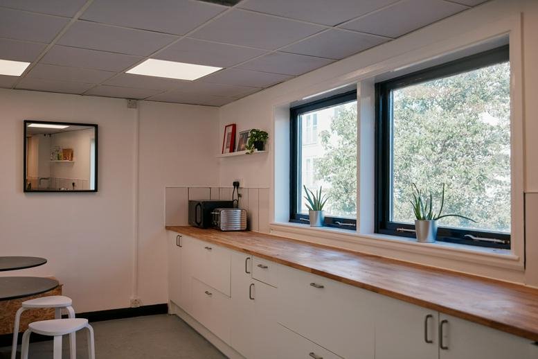 Modern kitchen and breakroom area at 41, Biggin Street, Loughborough, Leicestershire with wooden countertops.