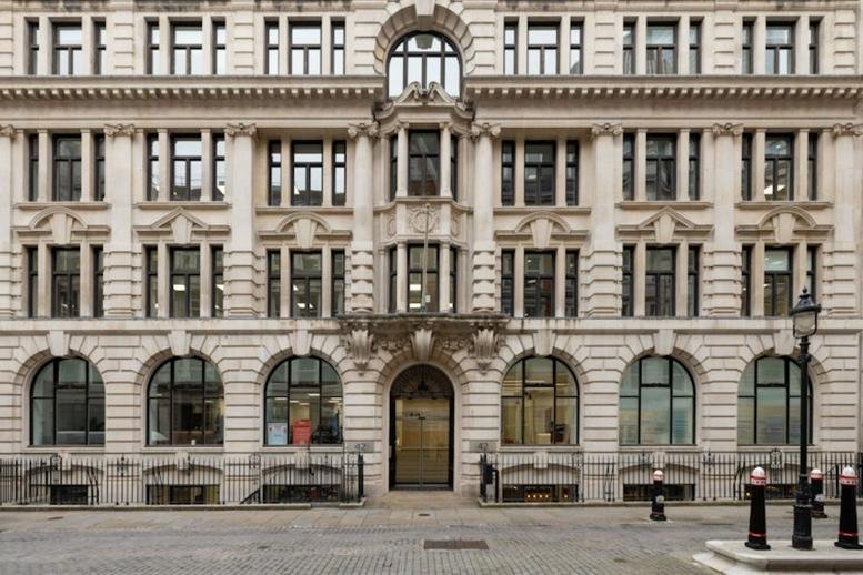 Grand stone facade and arched entrance of 42 New Broad Street.