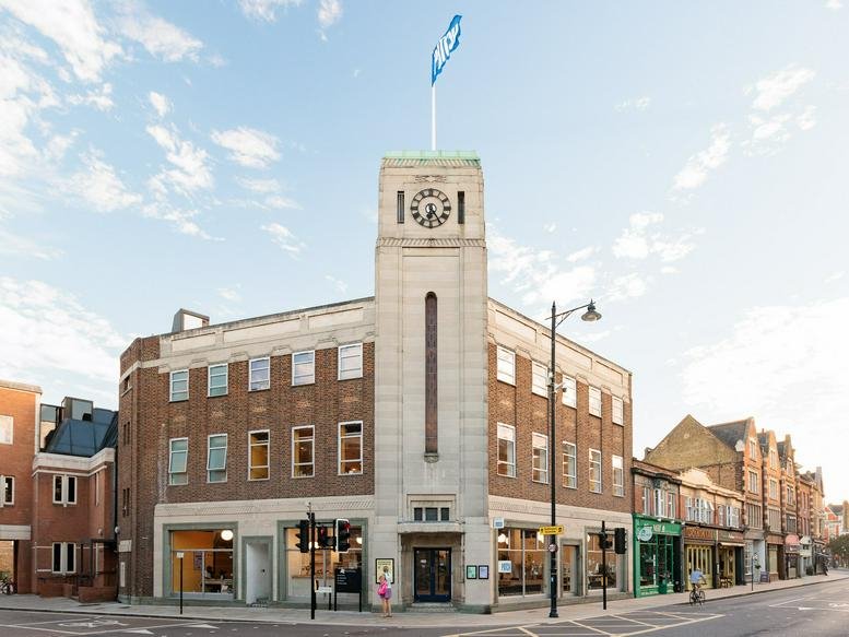 Exterior view of the historic brick and stone Electricity Board Building with a prominent clock tower.