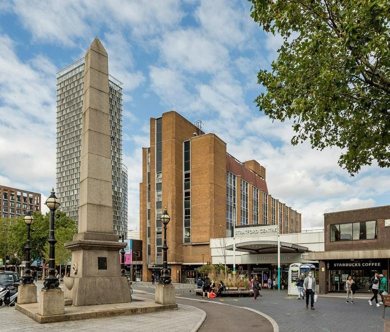Exterior view of the historic obelisk and surrounding modern buildings at 44 Broadway, Stratford, London.