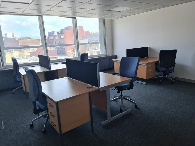 Spacious open-plan workspace at 44 Broadway, Stratford, London with multiple desk banks and city views.