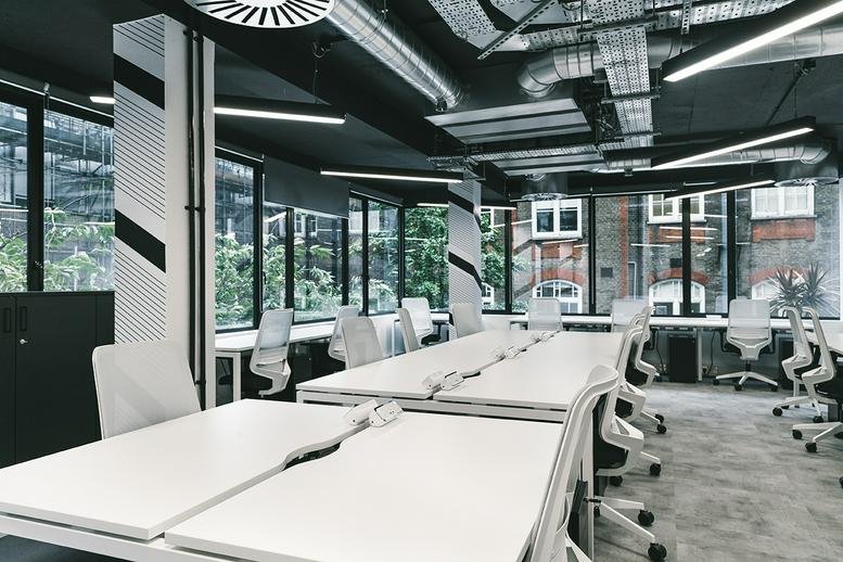 Large open-plan workspace at 44 Ingestre Place, Ingestre Court, with white desks and industrial pipes.