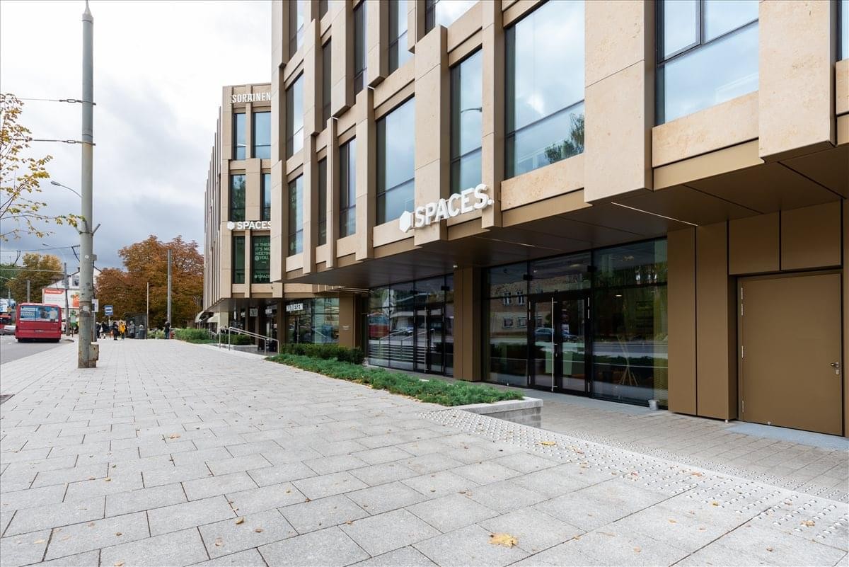 Exterior view of the modern stone and glass facade at 44A Gedimino Avenue, Vilnius.