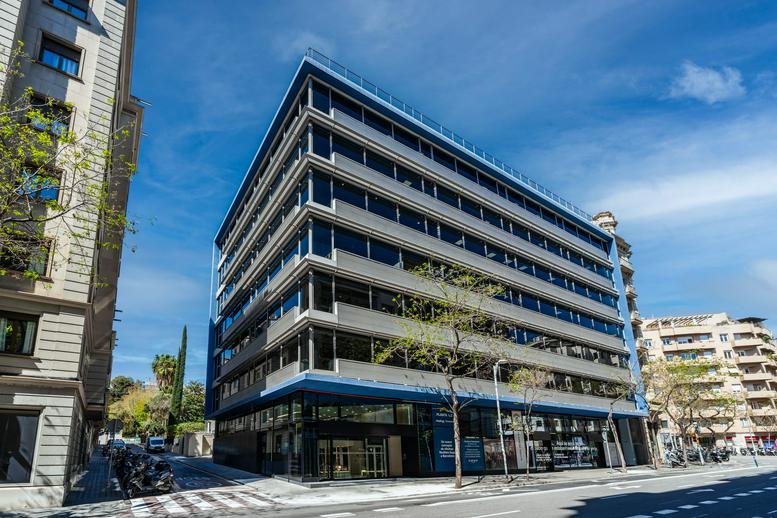 Exterior view of the multi-story modern office building at 47, 49, Travessera de Gràcia, Barcelona.