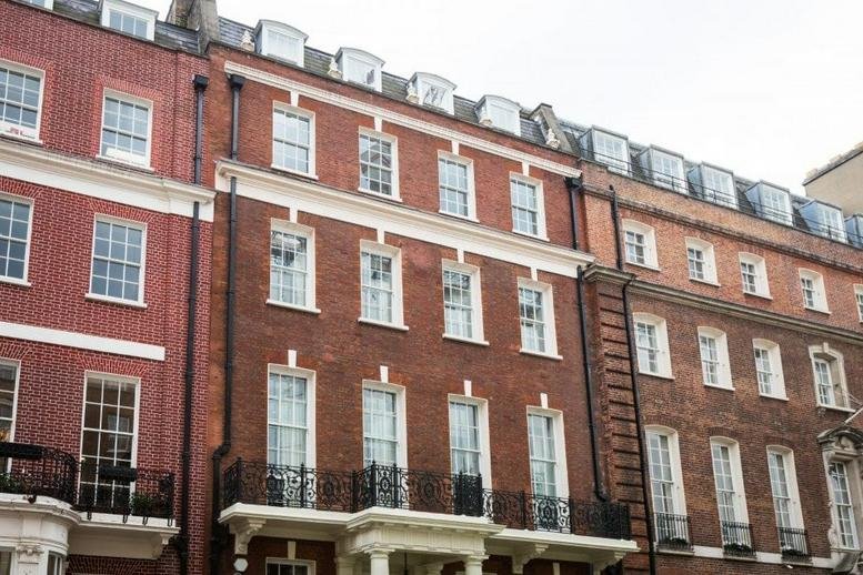 Exterior view of the classic red-brick facade at 49 Grosvenor Street, Mayfair.