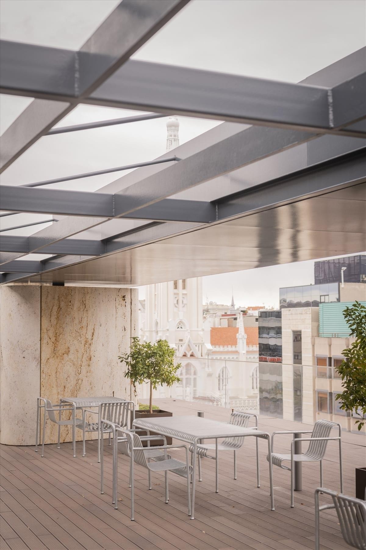 Rooftop terrace at 5-8F C. de Velázquez, 34, Madrid with modern outdoor furniture and city views.