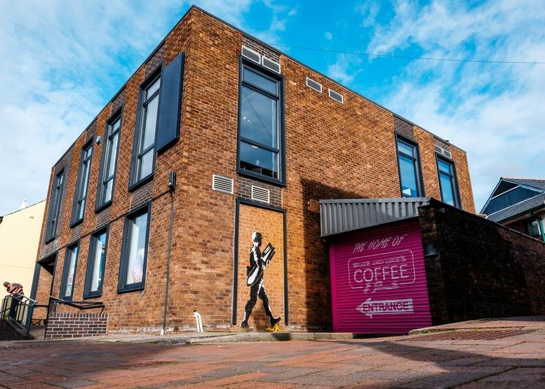 Exterior view of the brick facade and entrance at 5 Abbey Street, Carlisle.