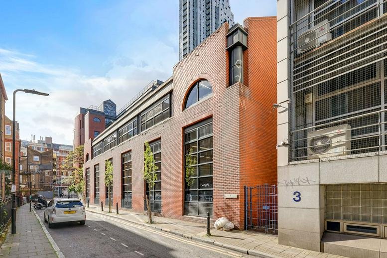 Exterior view of the red brick building facade at 5 Cranwood Street, London.