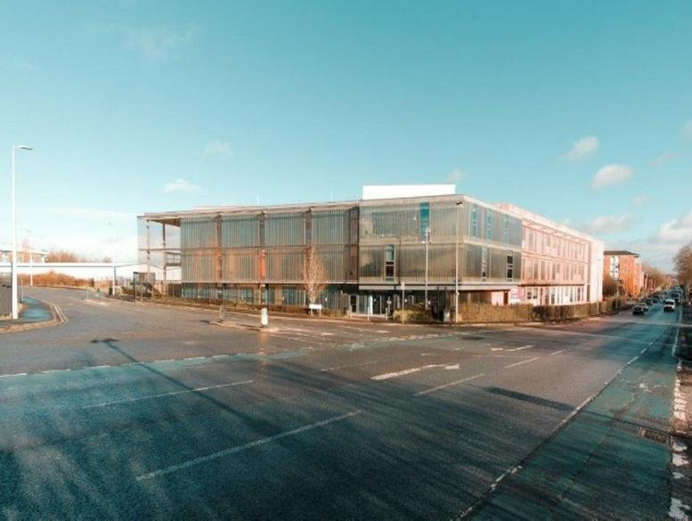 Exterior view of the modern glass and brick building at 51 Frederick Road, Salford.