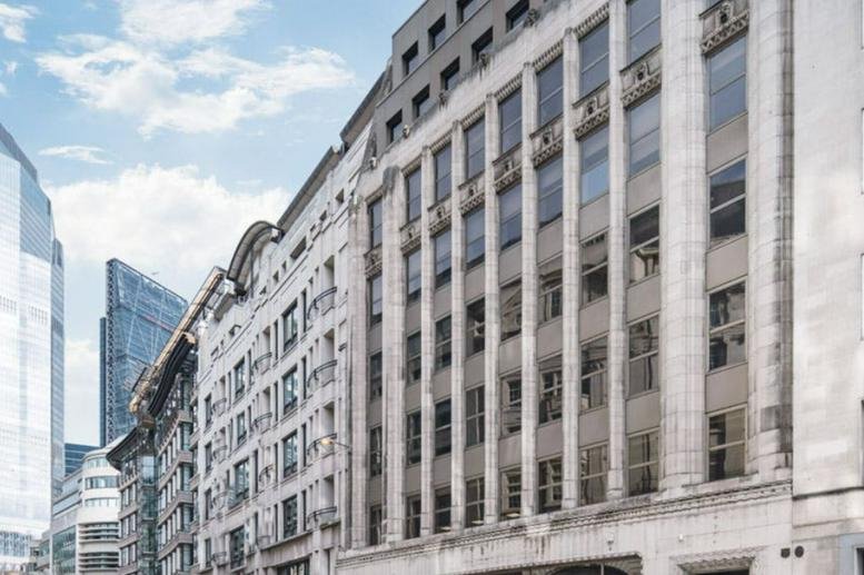 Exterior of a classic stone building with large windows.