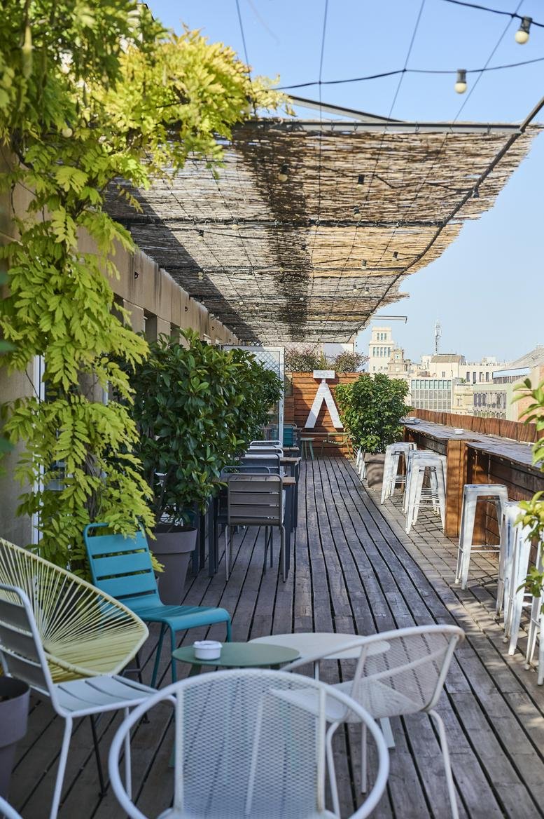 Rooftop terrace with seating and city views.