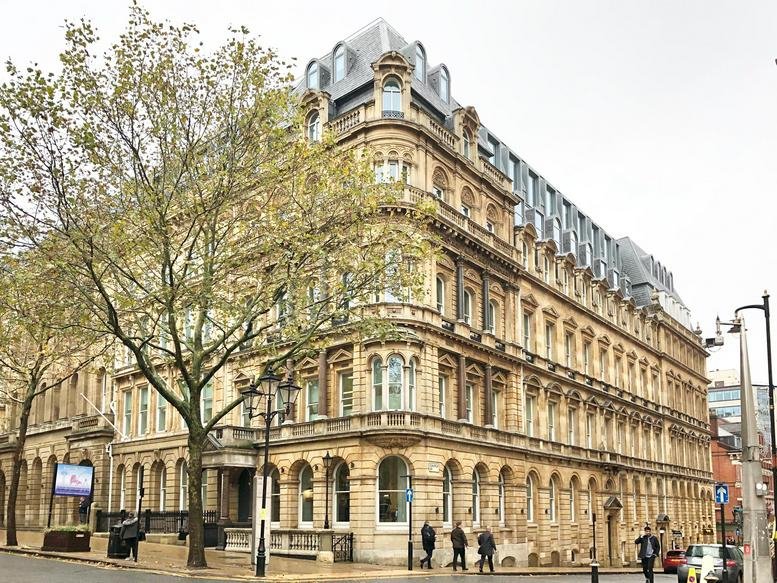 Exterior view of the historic stone facade at 55 Colmore Row, Birmingham.