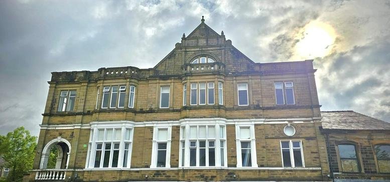 Exterior view of the historic stone facade at 57- 65 Burnley Road, Padiham, Lancashire.