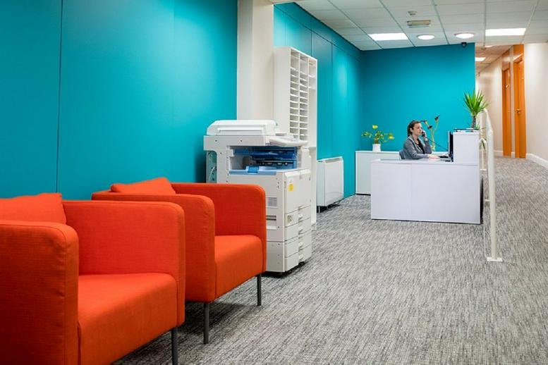 Reception and waiting area with bright teal walls and orange armchairs at 57 Clontarf Road, Northside, Dublin 3.