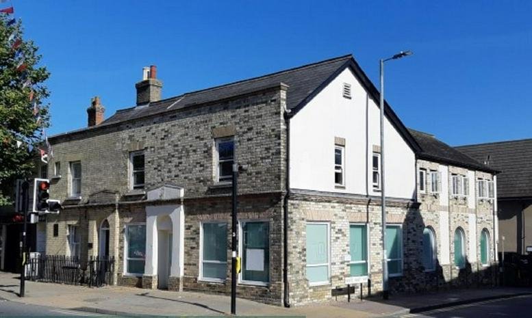 Exterior stone and white facade of the office building at 59-61 High St, Great Dunmow.
