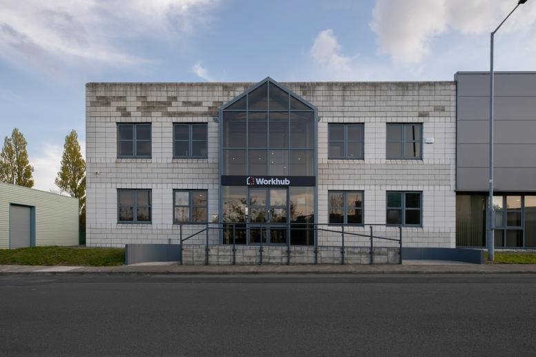 Exterior view of the light stone facade and glass entrance at 6 Fern Road, Dublin, Ireland.
