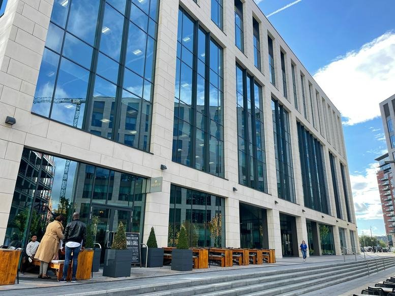 Exterior view of the contemporary stone and glass facade of 6 Wellington Place.