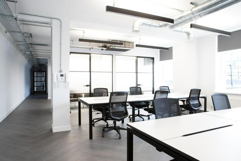 Spacious open-plan workspace at National House, 2nd Floor, 60-66 Wardour Street with white desks and mesh chairs.