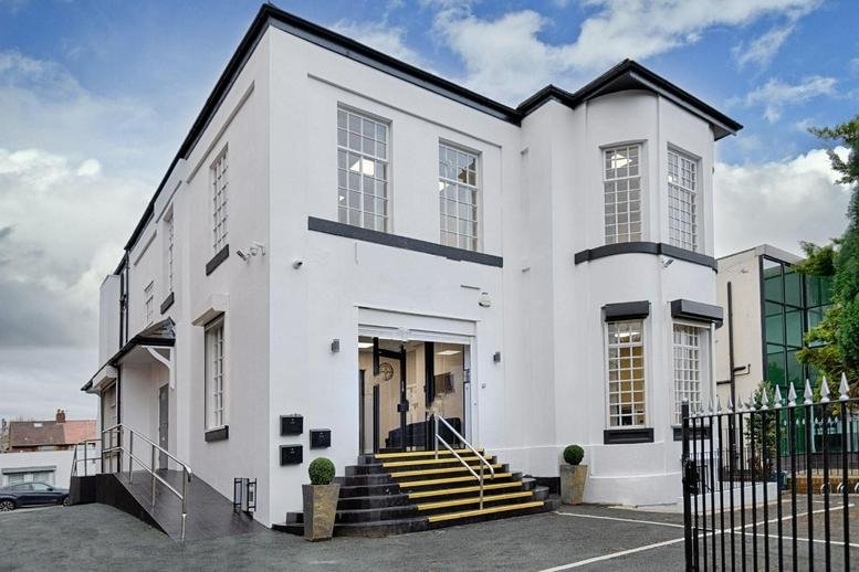 Exterior view of the white period building at 609 Stretford Road, Manchester.