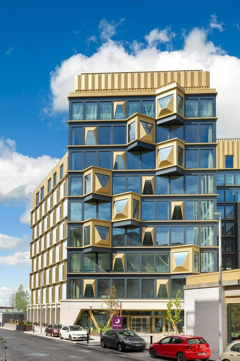 Modern exterior of the geometric gold and glass building at 63 Sheriff Street Upper.
