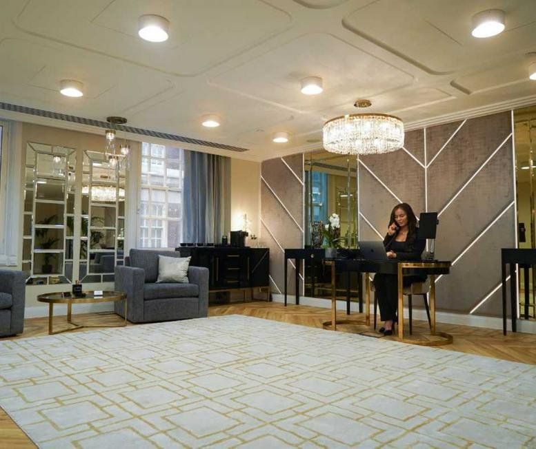 Reception area at 64 North Row, Park Lane with chevron wood walls and a front desk.
