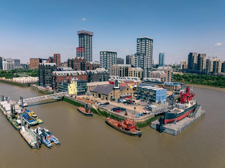 Aerial view of the industrial-style complex at 64, Orchard Place, London surrounded by water.