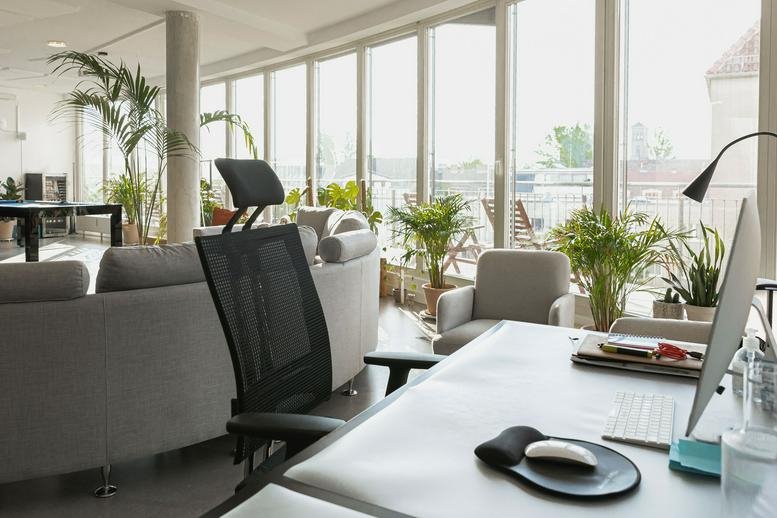Bright open-plan workspace at 64b, Engeldamm, Berlin, Germany featuring desk setup and a large lounge area.