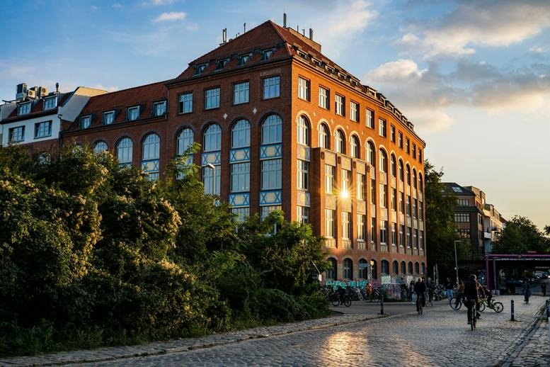 Exterior view of the red brick 65, Lohmühlenstraße, Berlin building at sunset.