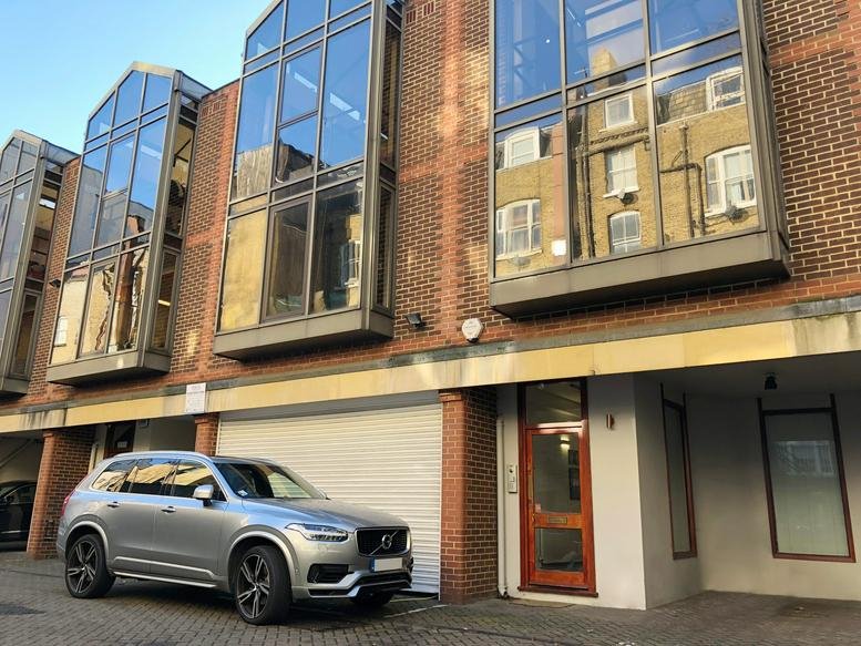 Exterior view of the modern brick and glass facade at 7-8 Crescent Stables.