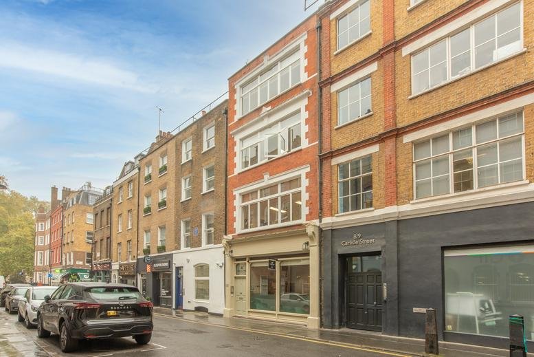Exterior street view of the brick building at 7 Carlisle Street, Soho, London, City of Westminster.
