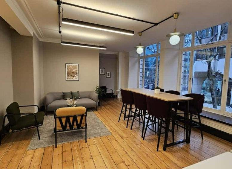 Casual lounge area with a grey sofa and bar-height communal seating.