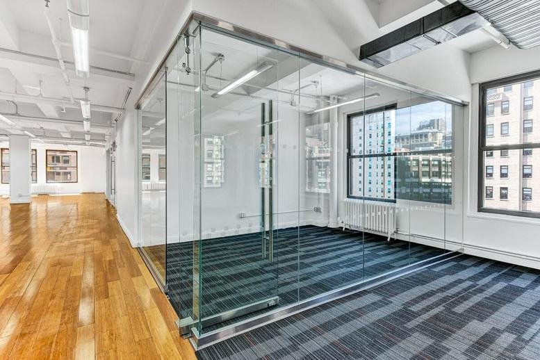 Spacious interior at 5th Floor, 7 Soho Square, Westminster featuring glass-walled offices and wood floors.