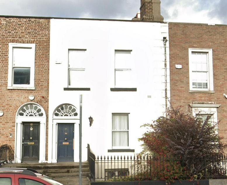 Exterior view of the white and brick facade at 70 Amiens Street.