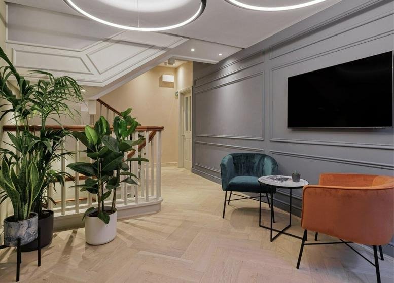 Elegant reception area at Borough Townhouse, 70 Borough High Street, featuring plush seating and indoor plants.