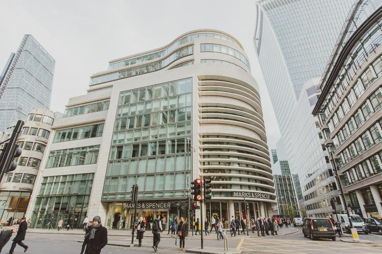 Exterior view of the curved glass and stone facade at 70 Gracechurch Street, London.