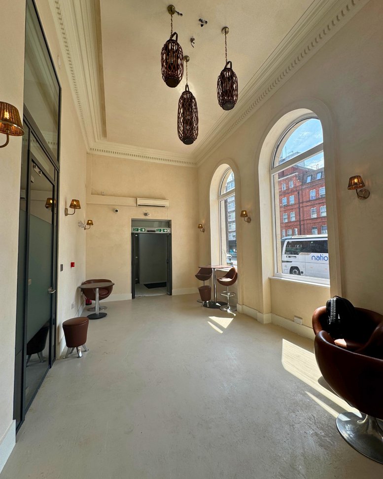 Bright common area with arched windows and lounge seating at 708 A High Road North.