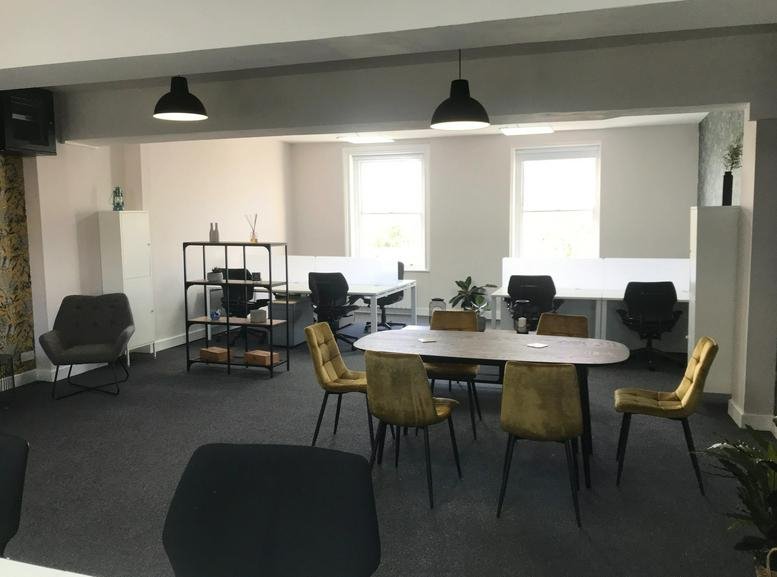 Spacious open-plan office at 74-76 Mount Pleasant Road with workstations and yellow accent chairs.