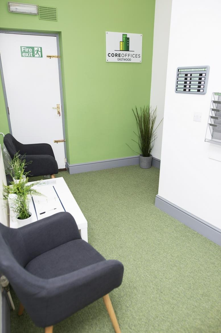 Reception hallway at 8 Mansfield Road, Eastwood, Nottingham featuring green carpets and signage.