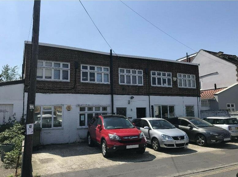 Exterior view of the brick and white facade at 8 Second Cross Road, Twickenham.