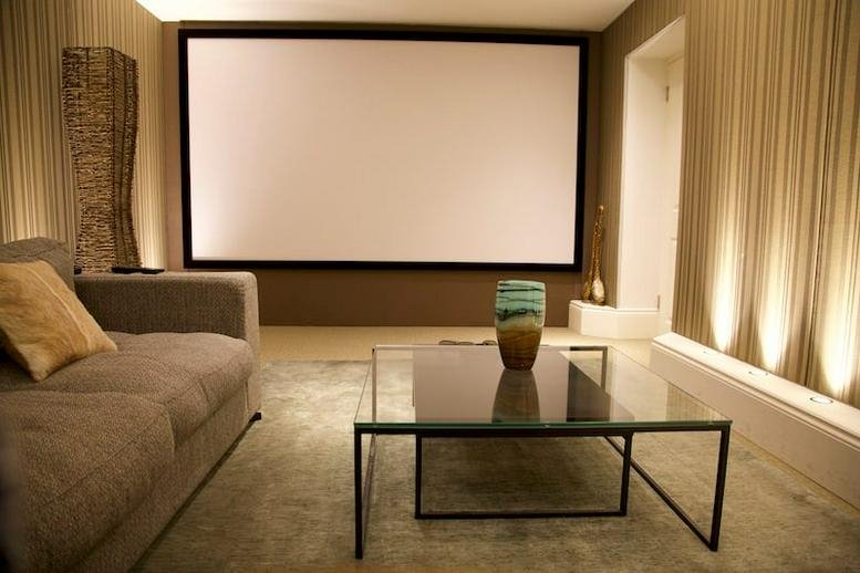 Spacious media room at 83 Lavender Hill, Clapham Junction featuring a large projector screen and plush sofa.