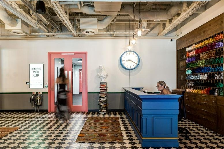 Spacious reception area of Mindspace, 9 Appold St, London, with blue desk and checkered floor.