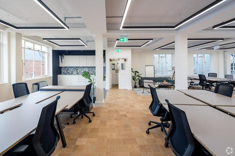 Spacious open-plan workspace at 90-93, Cowcross Street, London with modern lighting and wood-style flooring.
