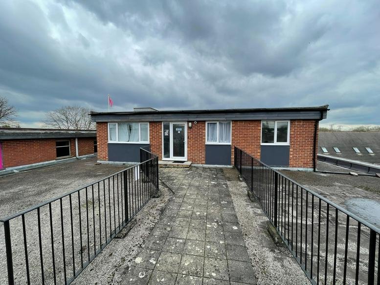Exterior view of the brick and grey facade of 91-99 Botley Road, Oxford.